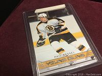Photo of Phil Kessel rookie card from Upper Deck Young Guns series, showing the player in Boston Bruins gear on ice surface.