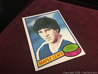 Front view of 1980 Rick Vaive rookie card showing player portrait in Maple Leafs blue jersey with name and team logo.