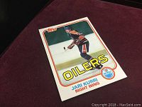 Front of 1981 Topps Jari Kurri rookie hockey card showing player in Edmonton Oilers uniform skating with hockey stick on ice with Oilers logo and team name.