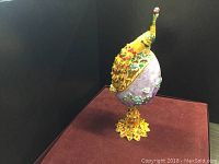 Side angle of Faberge inspired peacock egg showing detailed crystals and peacock head design.
