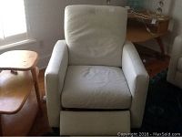 Front view of the white leather recliner chair with extended footrest.