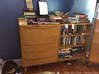 Front view of desk showing four drawers and open shelving