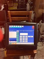Front view of the Radiant P1550 touch screen showing POS software interface.
