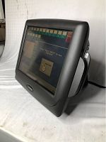 Front angled view of the Radiant P1550 POS touchscreen computer displaying login screen with numeric keypad and buttons.