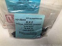 Close-up of a single screw in a clear bag labeled with specifications, showing 8 x 2 Special Pancake Quadrex Low Root Black JS screws with CW #14x3 bit, manufactured in Canada by Leland Industries Inc.