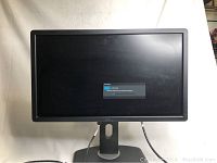 Front view of Dell P2312H monitor screen with power off and a message.