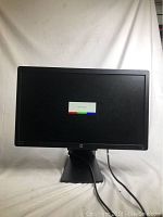 Front view of HP 24 inch monitor power on screen with no signal message. Monitor is black with matte screen and supported by a wide black stand base.