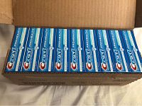 Opened box showing 36 individual Crest Pro-Health toothpaste tubes neatly packed inside.