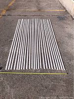 All 24 pieces of shoe moulding laid out in 3 rows showing full length and quantity