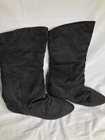 Pair of black faux suede calf high boots viewed from above, showing full length and shape.