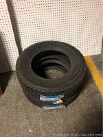 Pair of two stacked Toyo winter tires showing size and tread pattern.