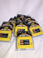 Ten packs of Duracell AA alkaline batteries arranged in a semi-circle on a white surface.