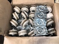 Box containing 12 white nylon swivel castor wheels with metal mounting plates.