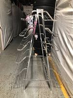 Side view of the 6 tier metal shoe rack showing the wire racks and folding frame