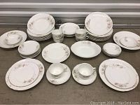 Full set displayed showing all plates, cups, saucers, bowls arranged in groupings on floor