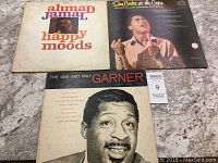 Three vintage vinyl record albums: Ahmad Jamal Happy Moods, Sam Cooke At the Copa, and Erroll Garner The One and Only.