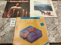 Three vintage vinyl record albums arranged on a surface: Christmas with Mahalia, Winter Wonderland by Earl Grant, and Jesus Paid It All by Rev. R. L. White Jr. and Rev. Donald Vails.