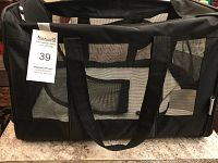 Side view of black soft-sided pet carrier with mesh panels and handles