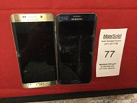 Front view of gold and black Samsung Galaxy S6 Edge+ phones with cracked screens