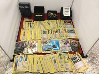 Wide view of the Pokemon cards spread out in multiple stacks along with two card holders and the dice compartment visible.