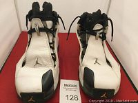 Front view of men's Air Jordan XX1 PE sneakers in white and black.