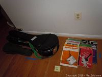 Overview of two hardshell cases on floor with sheet music to right