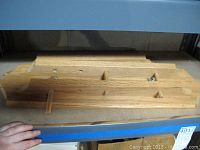 Wooden stein rack close-up, showing slots and pegs for holding steins