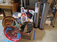 Overview photo showing multiple metal beer trays from Schlitz, Old Style, Miller High Life, and Corona, along with bottles, cans, and accessories arranged on a box.