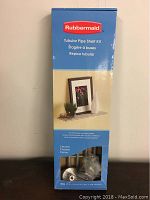 Box showing Rubbermaid branding, product image with shelf holding decor items, and overview of packaging size.