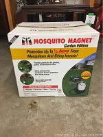 Closed Mosquito Magnet Garden Edition cardboard box showing product branding and usage area coverage of up to 1/2 acre.