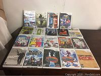 Photo showing 15 Wii game titles arranged on a table, identifiable by their original Wii packaging covers.