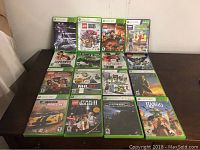 Photo of 15 Xbox 360 game cases laid out on a table.