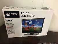Box of GPX 13.3 inch LED HDTV showing brand, size, and some key features such as LED display, HDMI, PC compatibility, and media port.