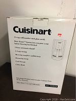 Box front showing Cuisinart branding and product features including 12-cup capacity, Brew Pause, auto shutoff, and color black.