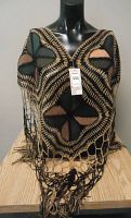 Poncho displayed on mannequin showing front geometric design and fringe