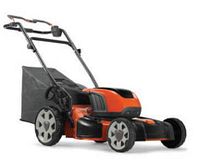 Orange and black Husqvarna push mower with grass bag attached
