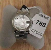 Front view of watch on display cushion showing dial, bracelet, and MaxSold tag