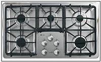 Top-down view of GE cooktop showing five burners, grates, and control panel