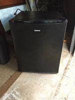 Closed front view of the black Galanz small refrigerator showing the exterior and logo.