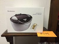 Box of Brookstone Ultrasonic Jewelry Cleaner showing the product image and description on the front.