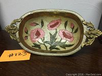 Full view of the oval brass bowl with cloisonne floral inlay and brass handles on each side