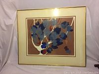 Full view of the framed print showing the abstract orchid tree design in blues and greys, framed in gold with cream mat.