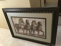 Framed horse wall art leaning against wall showing full piece and frame details.