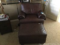 Chair, ottoman and floor lamp wide shot