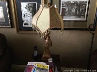 Full front view of lamp showing base and shade