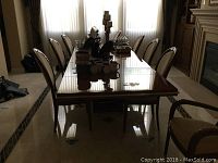 Full view of table extended with eight chairs in dining room