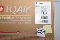 Close-up of box label showing IQAir branding and product details.