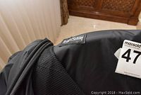 Close-up photo showing the Briggs and Riley logo patch on the garment bag fabric.