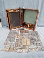 Ellams 60 diaphragm duplicator open with metal printing plates spread around.