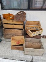Full view of all ten wooden crates stacked and arranged showing various sizes and printed graphics including Corned Beef and Zinfandel.